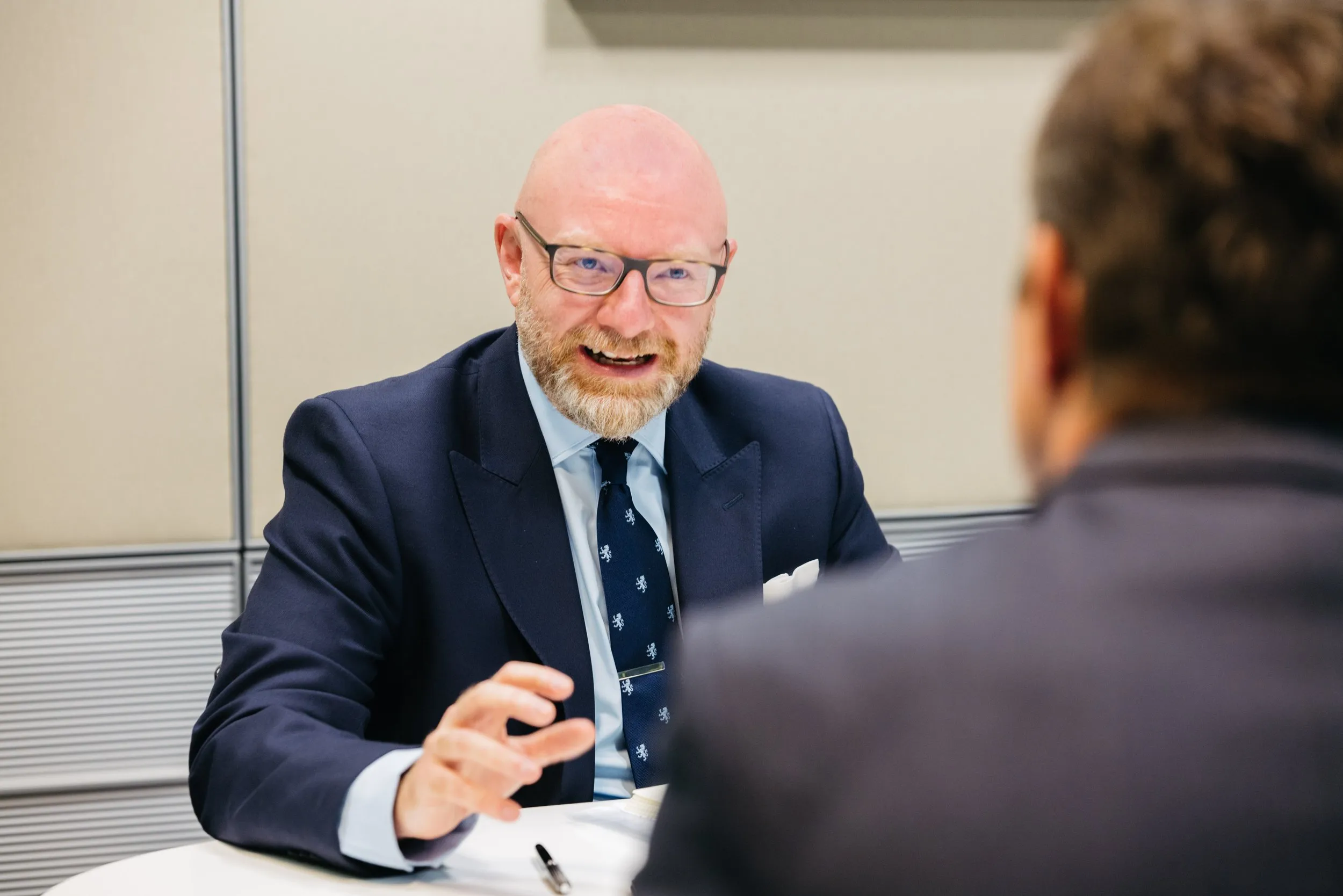 Financial services professionals in a meeting with City of London skyline, corporate branding photography