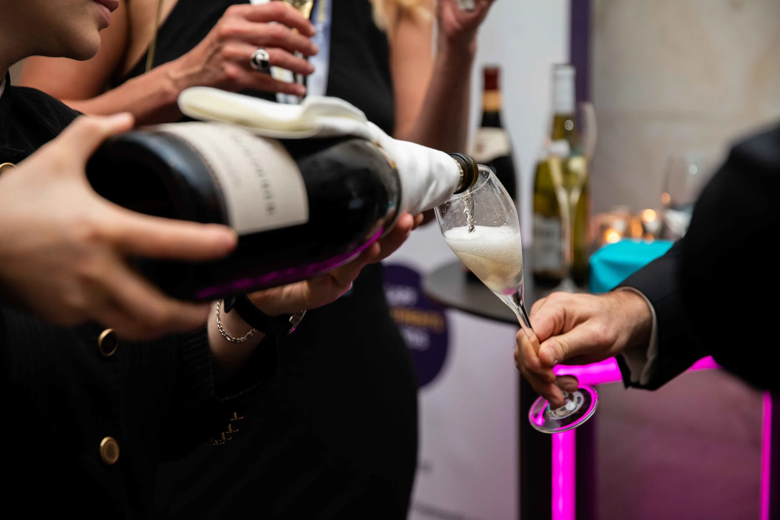 Champagne being poured at a corporate awards reception, London event photography