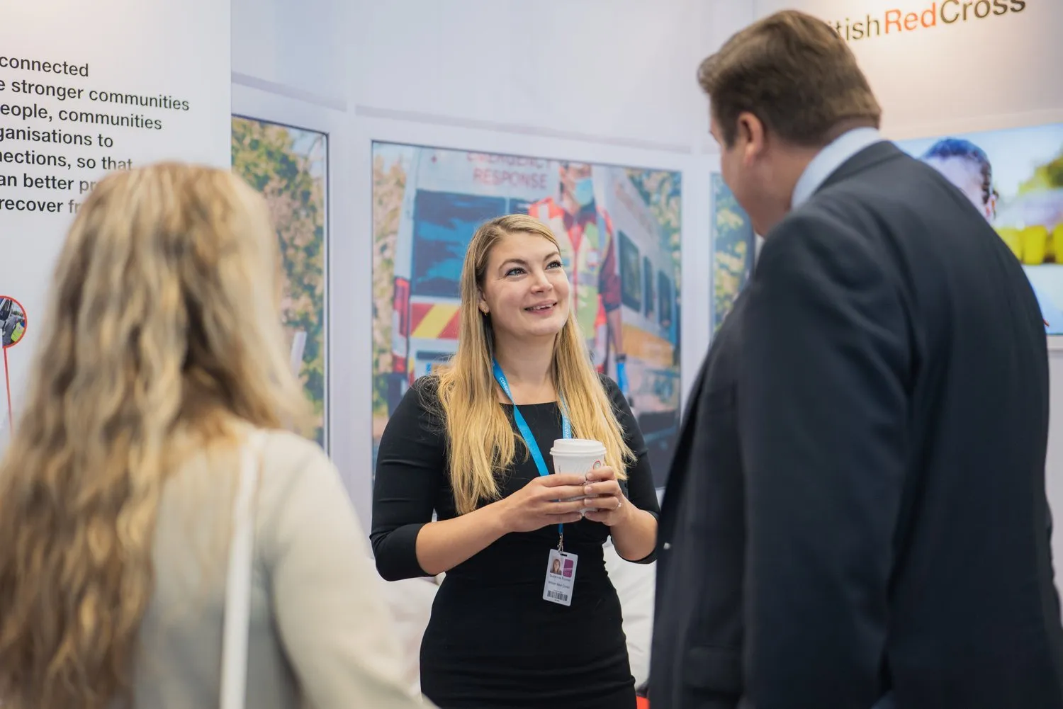 Networking at a corporate conference exhibition stand, London