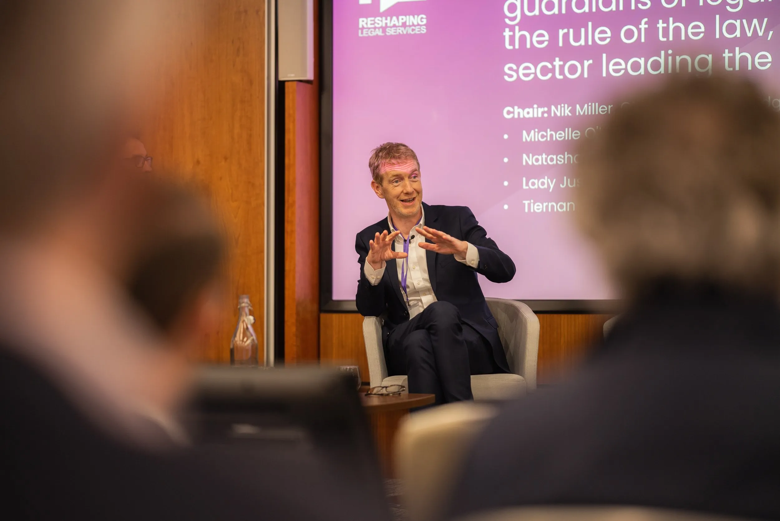 Panel chair speaking at a legal services conference, London conference photography