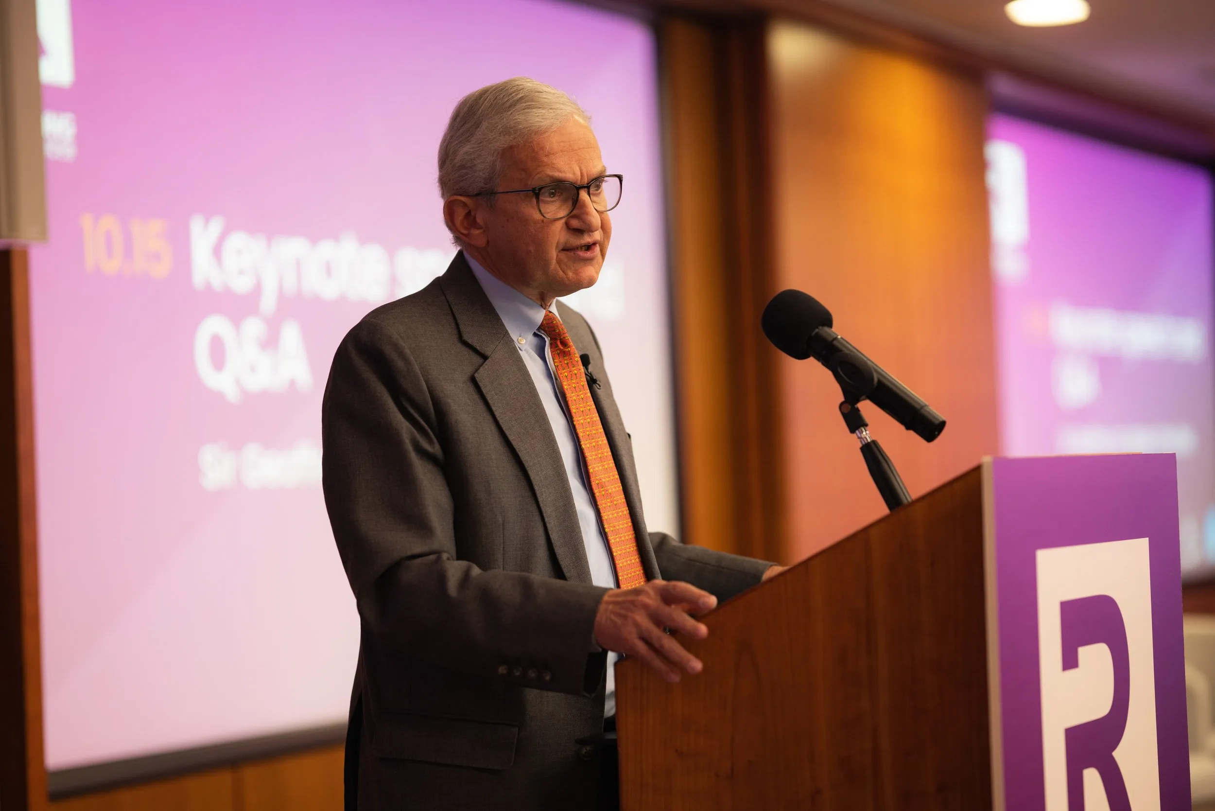 Senior keynote speaker at podium during a legal services conference, London