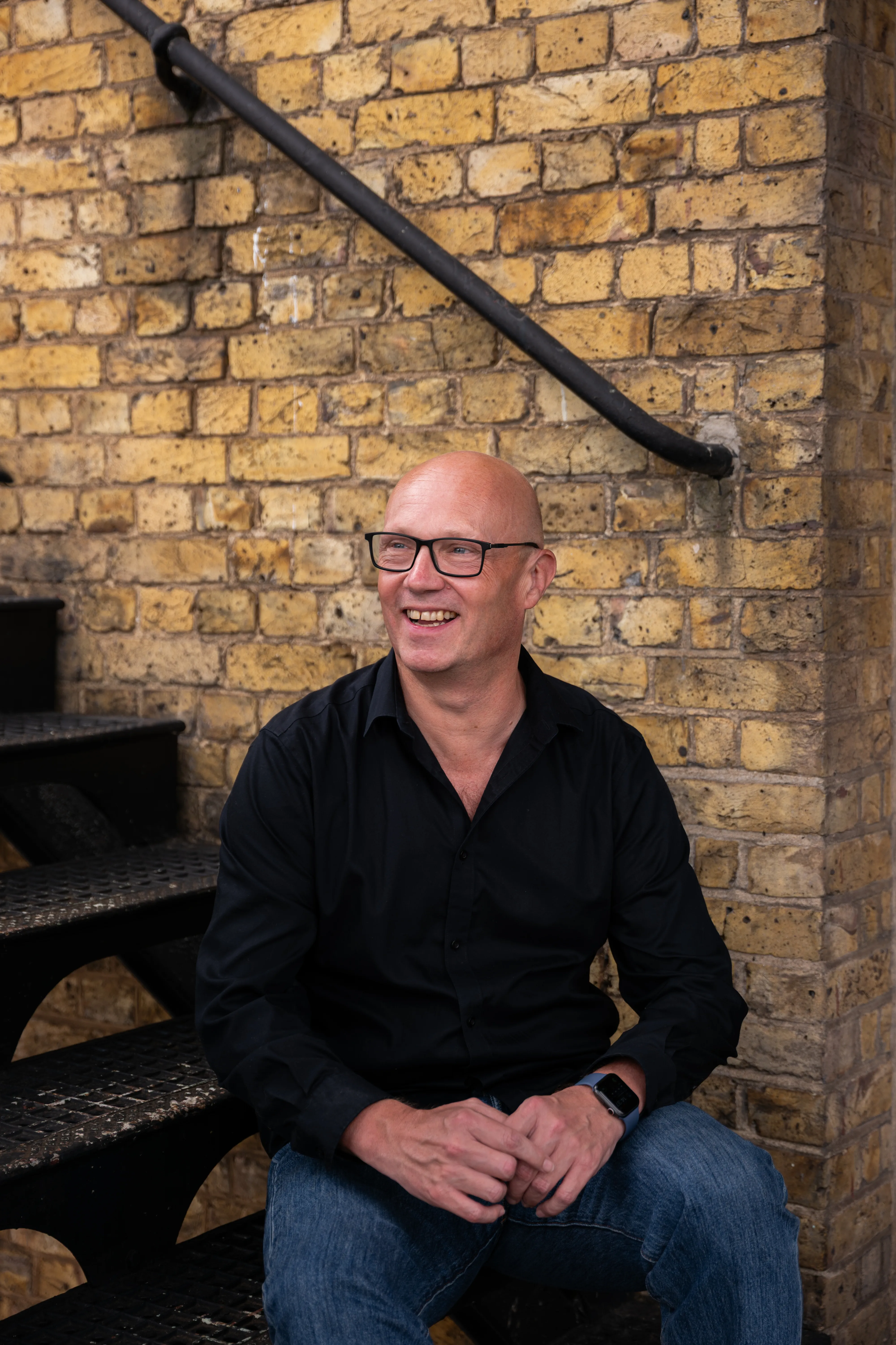 Executive informal lifestyle portrait at brick wall, London