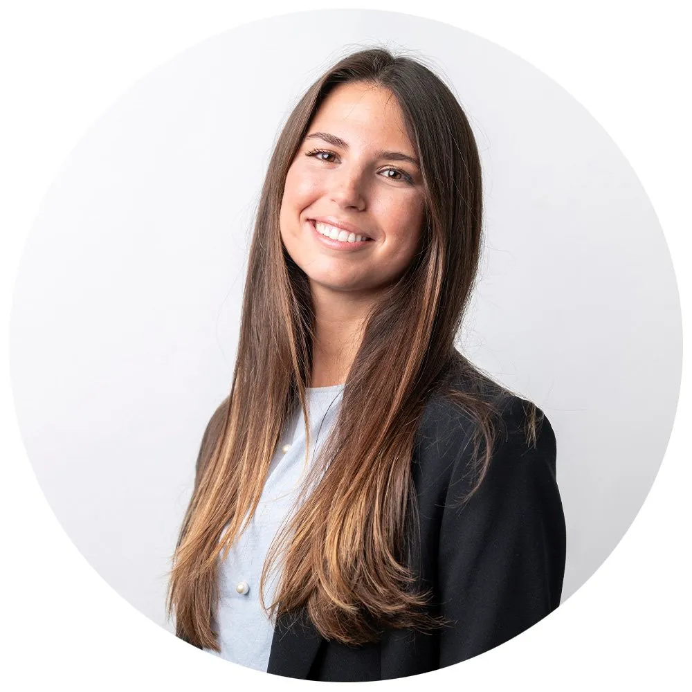 Professional headshot of young woman with dark hair in black blazer, London