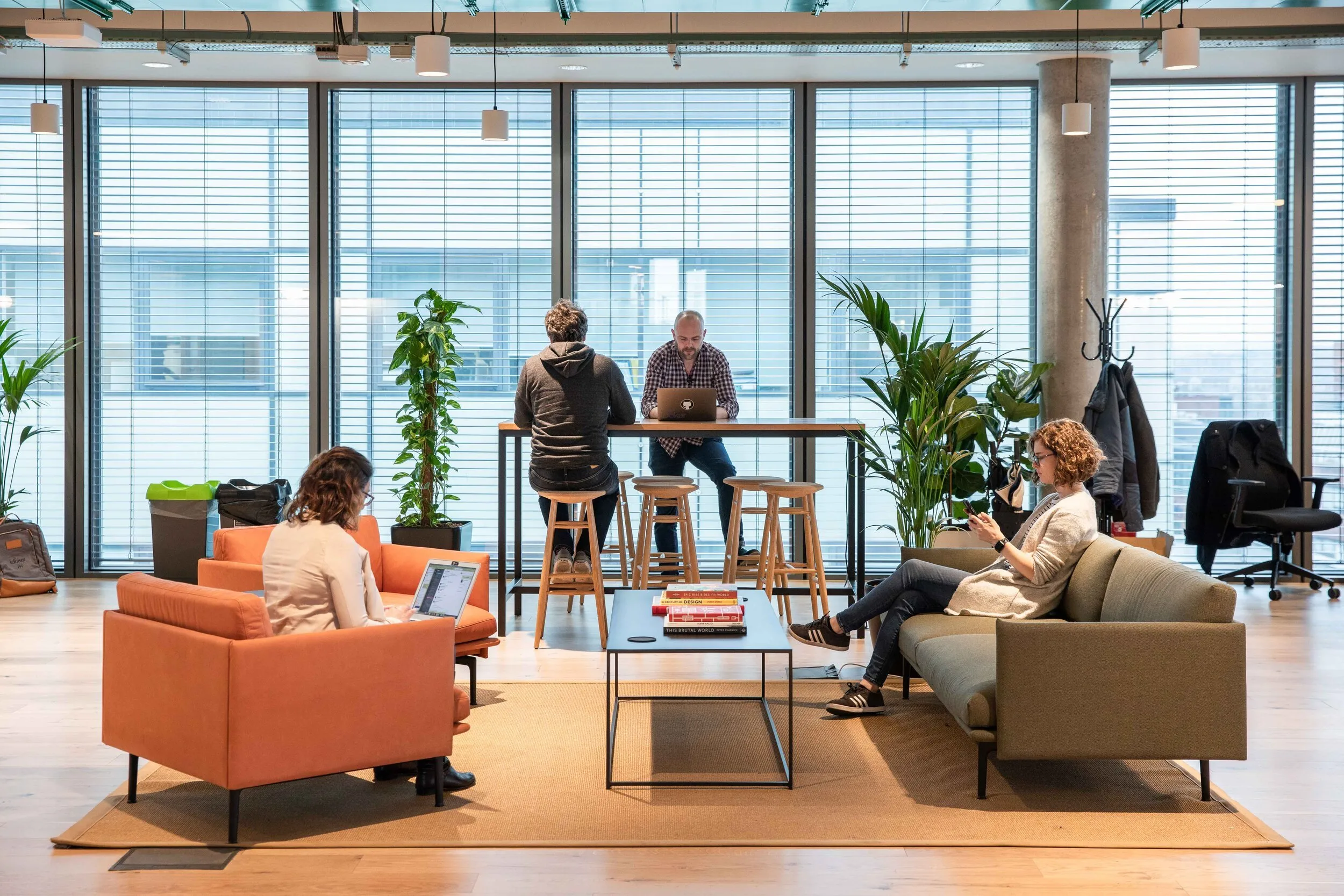 Tech startup team collaborating in open-plan office, corporate branding photography, London