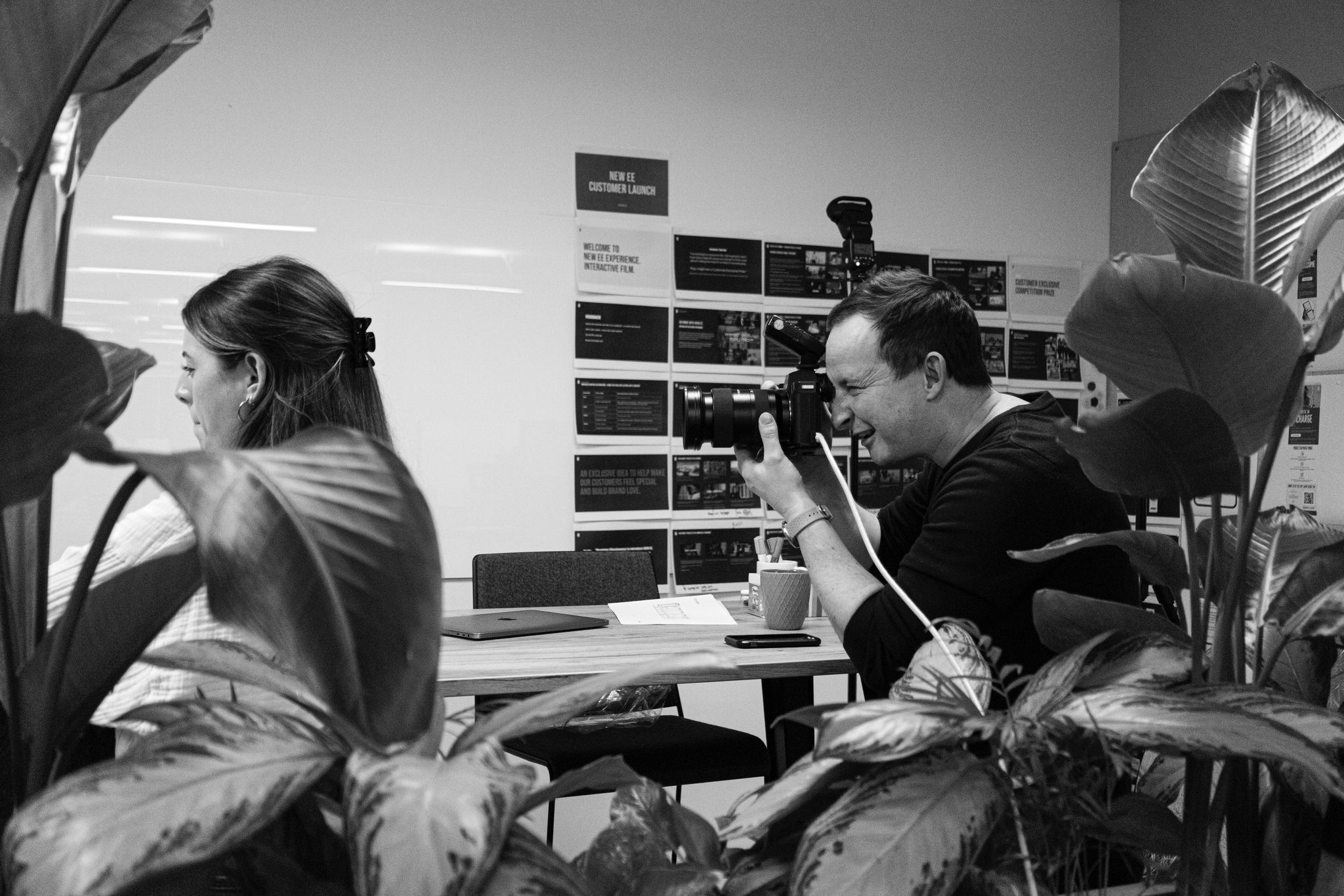 Behind the scenes: corporate photographer shooting through plants during London office lifestyle shoot