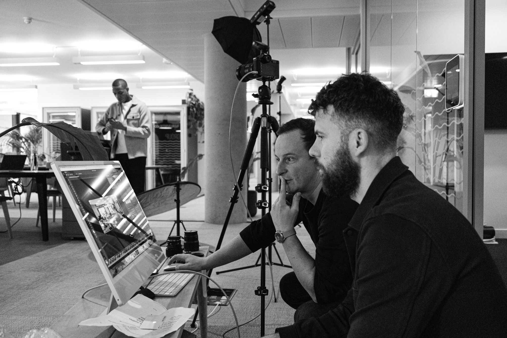 Behind the scenes at Sharp Electronics corporate lifestyle shoot — David McConaghy and Publicis Pro creative team reviewing selects on laptop in London office