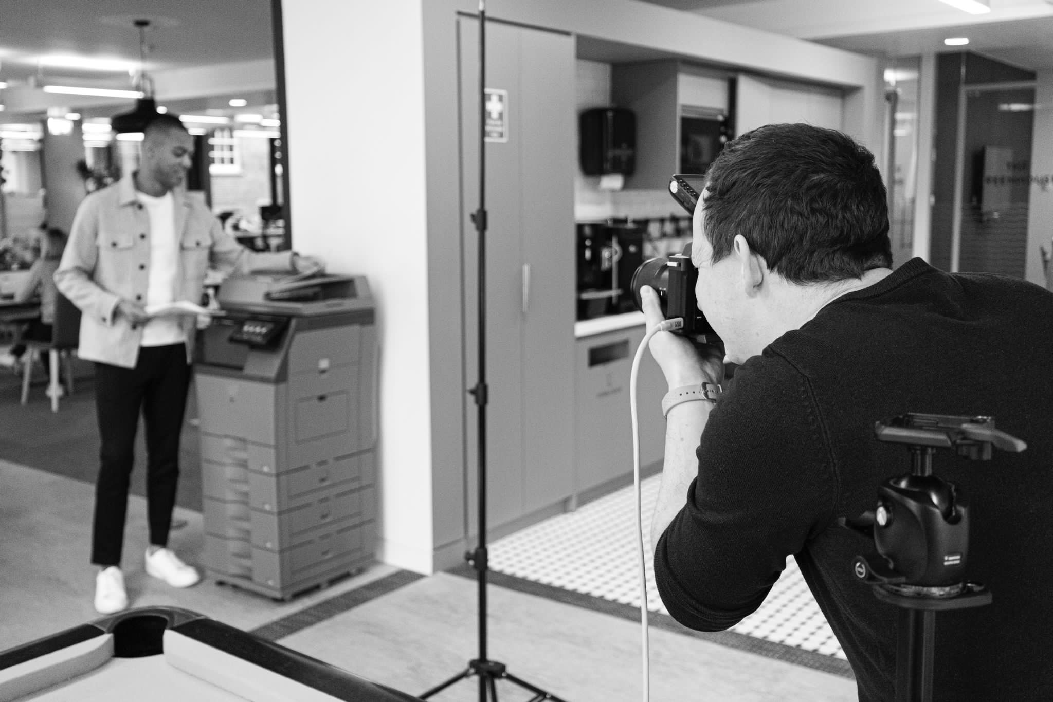 Corporate lifestyle photographer London — David McConaghy photographing talent alongside Sharp printer during Publicis Pro shoot
